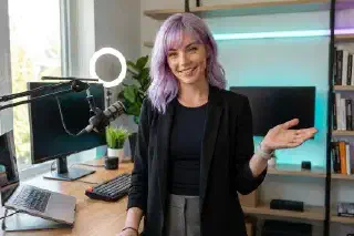 Mira welcoming visitors into her modern creator workspace