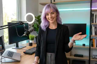 Mira welcoming visitors into her modern creator workspace
