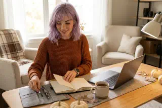 Mira at a calm autumn desk setup with notebook, laptop, and cozy ergonomic workspace details