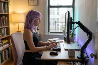 Mira at a compact desk using a monitor arm to free up workspace